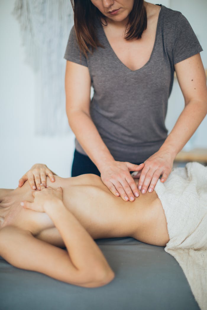 A calming indoor massage session with a woman receiving a spa treatment, enhancing relaxation.